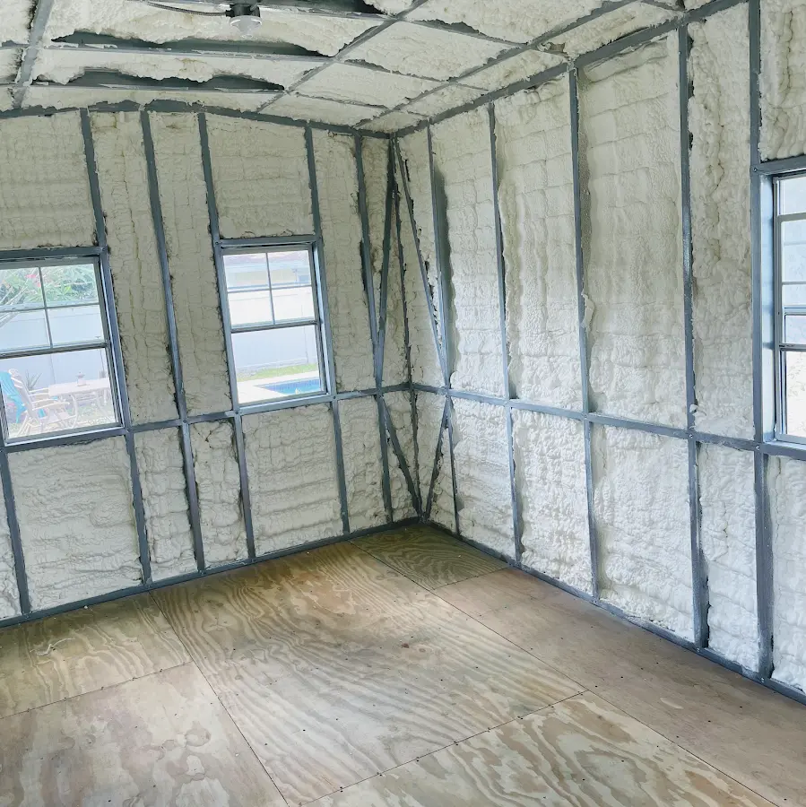 Closed-cell spray foam insulation applied to wall cavities in a residential project in Manor